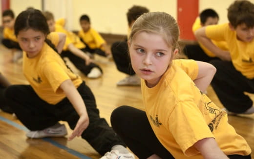 a group of children in yellow shirts