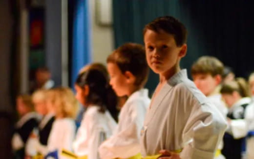 a group of children in white shirts