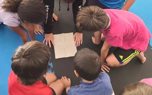 a group of children writing on paper