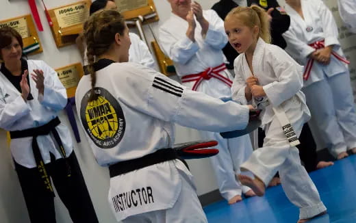 a group of women in karate uniforms