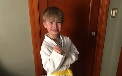 a boy with his arms crossed