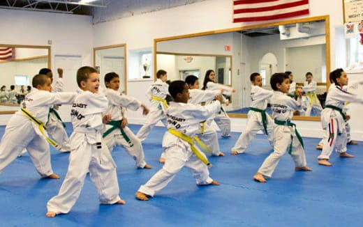 a group of children in karate uniforms