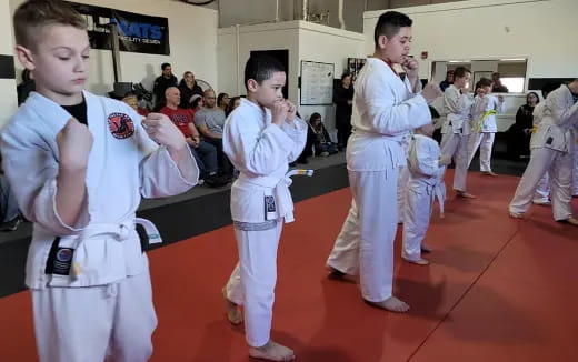 a group of kids in karate uniforms