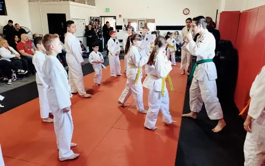 a group of people in karate uniforms