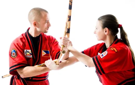 a man and a woman holding a bat