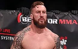 a man with a beard and tattoos