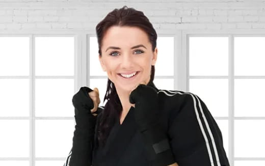 a woman smiling with her arms crossed