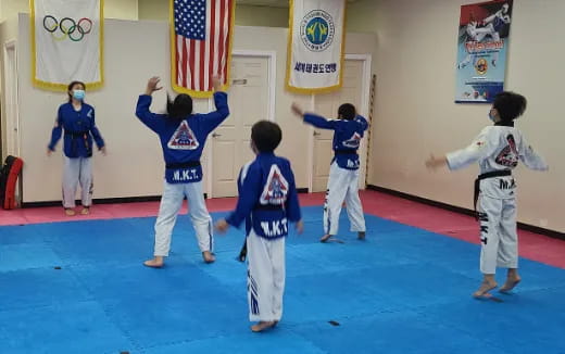 a group of kids in karate uniforms