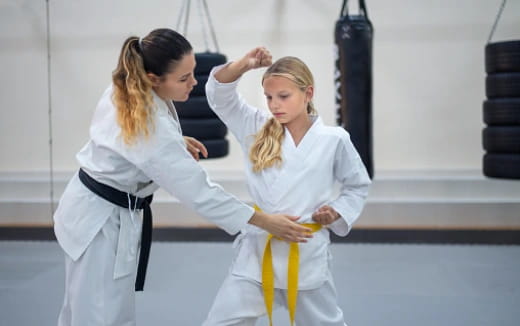 a few women in white karate uniforms