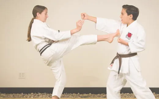 a man and a woman in karate uniforms