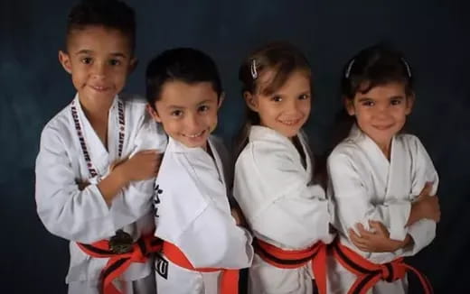a group of children in karate uniforms