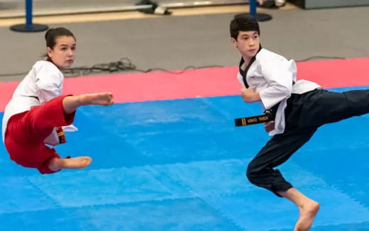 a couple of people in karate uniforms