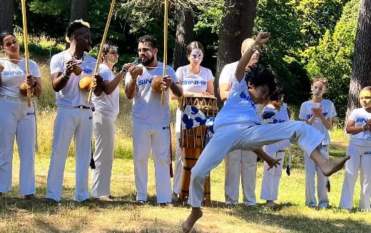 a group of people in white karate uniforms