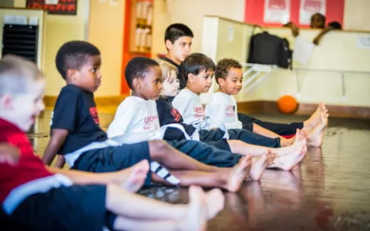 a group of boys sitting on the floor