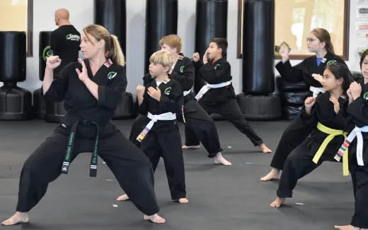 a group of people in black karate uniforms