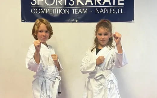 a couple of girls in white karate uniforms