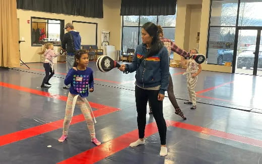 a person and a child in a gym