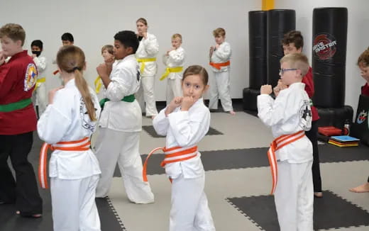 a group of children in karate uniforms