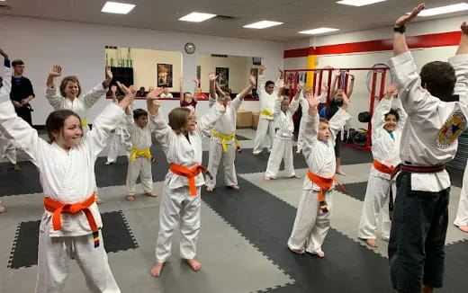 a group of people in karate uniforms