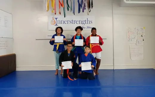 a group of people holding certificates