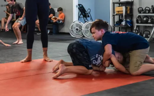 a person doing push ups on a mat in a gym