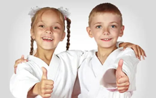a couple of children holding their hands up