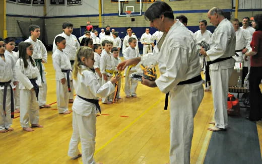 a group of people in white karate uniforms