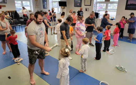 a group of people playing with a toy