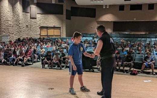 a person and a boy shaking hands