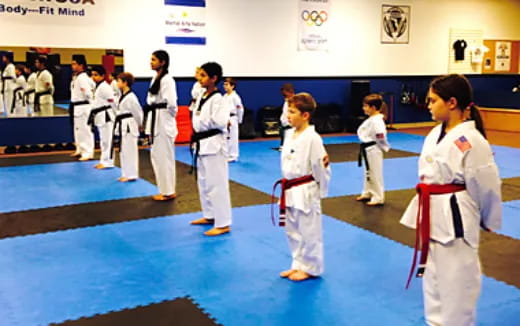 a group of people in karate uniforms