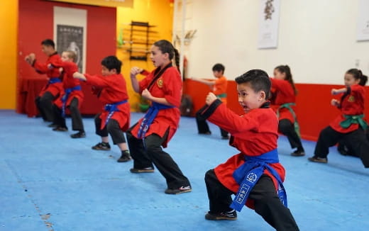 a group of children in red uniforms