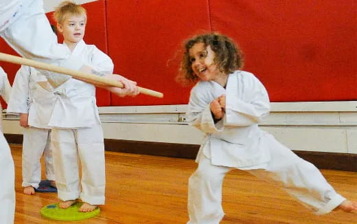 a group of kids in karate uniforms