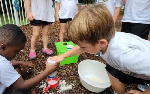 children playing with water in a bucket