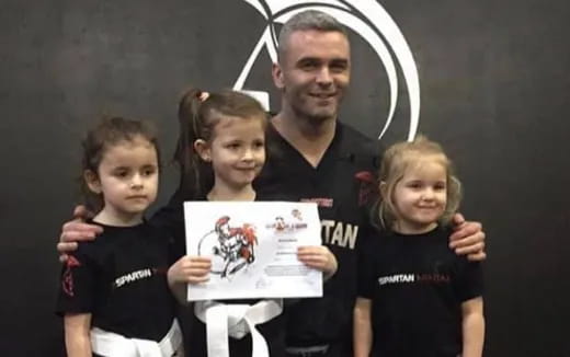 a person holding a picture with children