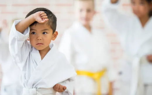 a young boy holding his head