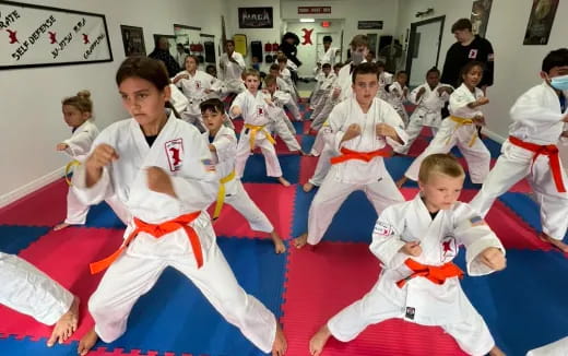 a group of children in karate uniforms
