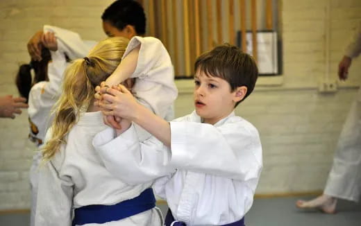 a boy and girl in karate uniforms
