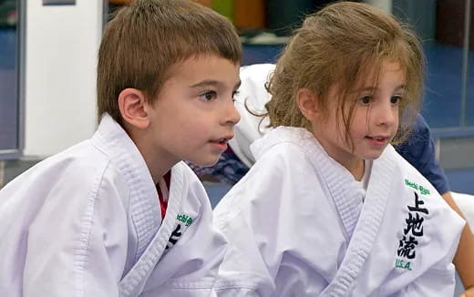 a couple of young boys wearing white shirts