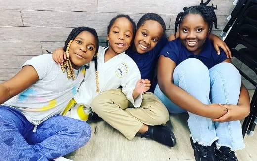 a group of children sitting on a bench