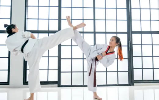 a couple of people in karate uniforms