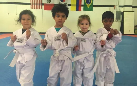a group of kids in karate uniforms