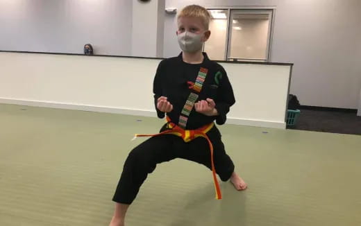a boy in a karate uniform