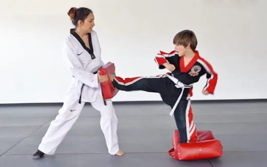 a person and a boy in karate uniforms