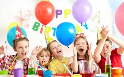 a group of children with balloons