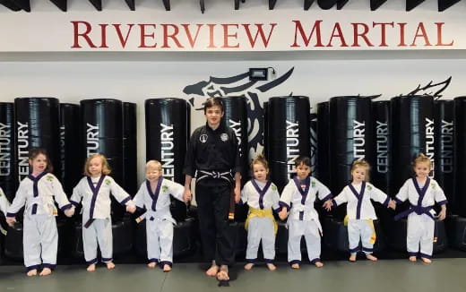 a group of children in karate uniforms