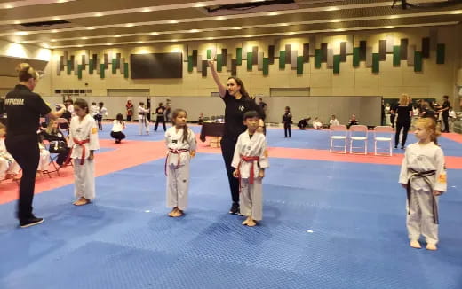 a group of children in a karate class