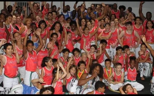 a group of people in red and white shirts