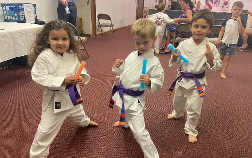 a group of children in karate uniforms