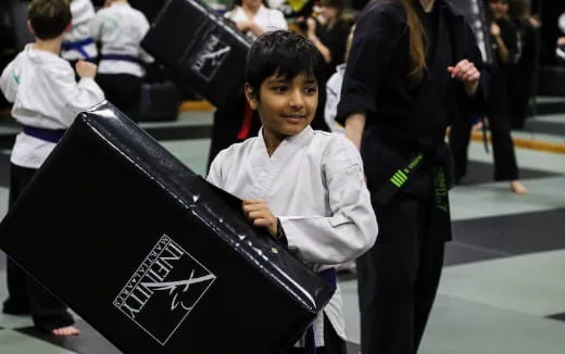 a boy holding a black umbrella