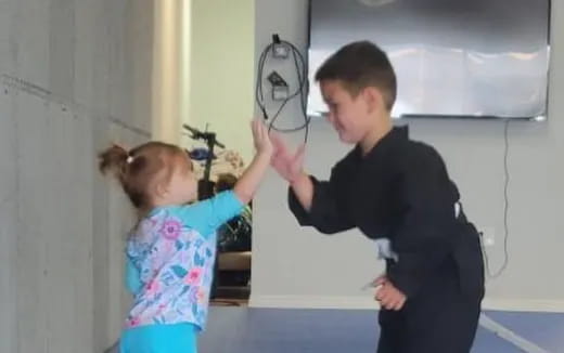 a boy and girl holding hands